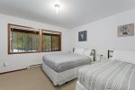 Plenty of space in this lower-level bedroom with both a queen & twin bed 